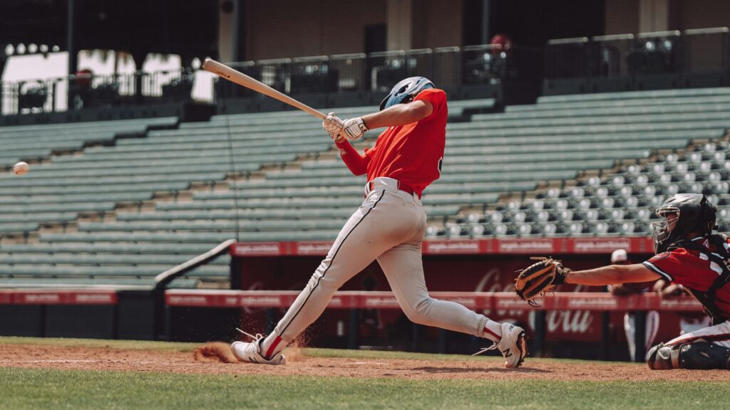 A young baseball player in a helmet holding a bat, ready to swing at home plate