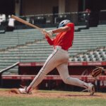A young baseball player in a helmet holding a bat, ready to swing at home plate