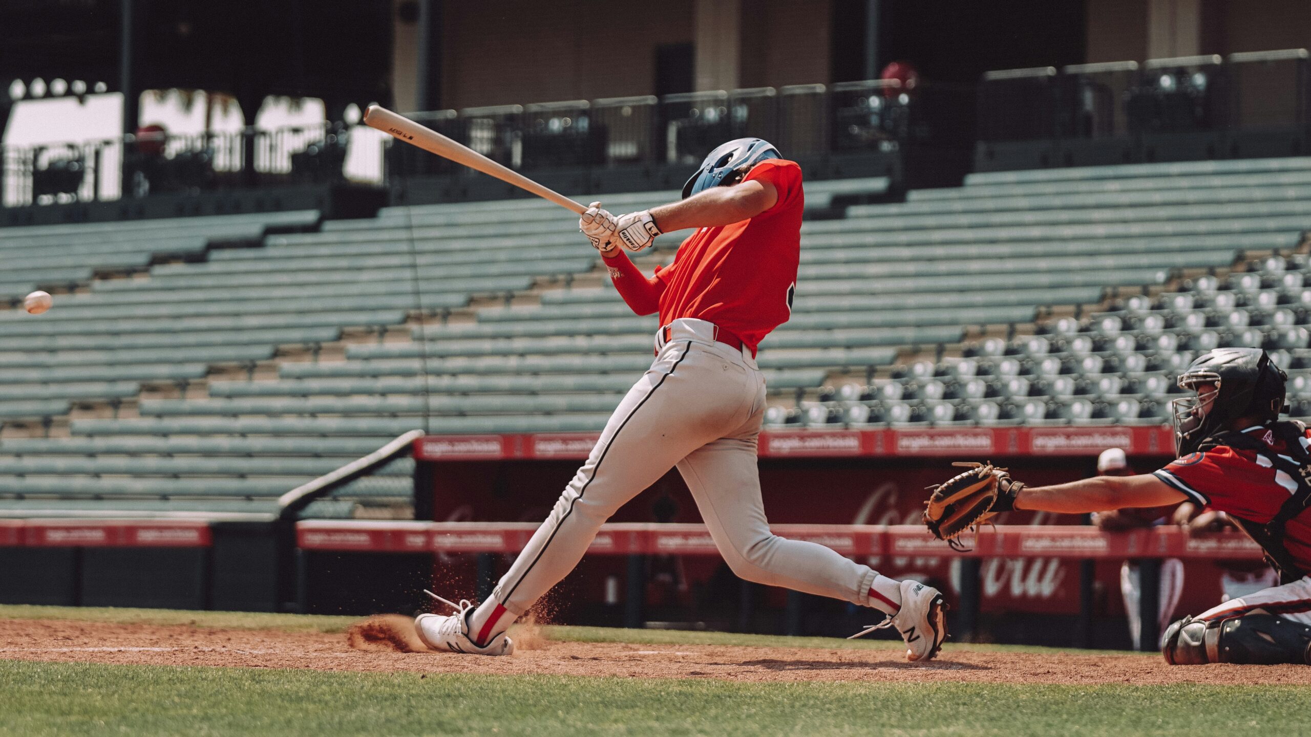 A young baseball player in a helmet holding a bat, ready to swing at home plate